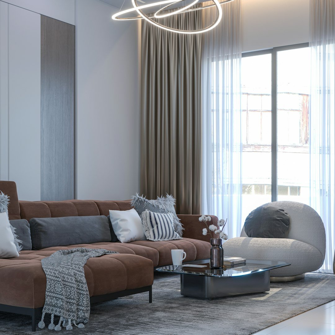 Elegant designer living room with velvet sofa and marble fireplace
