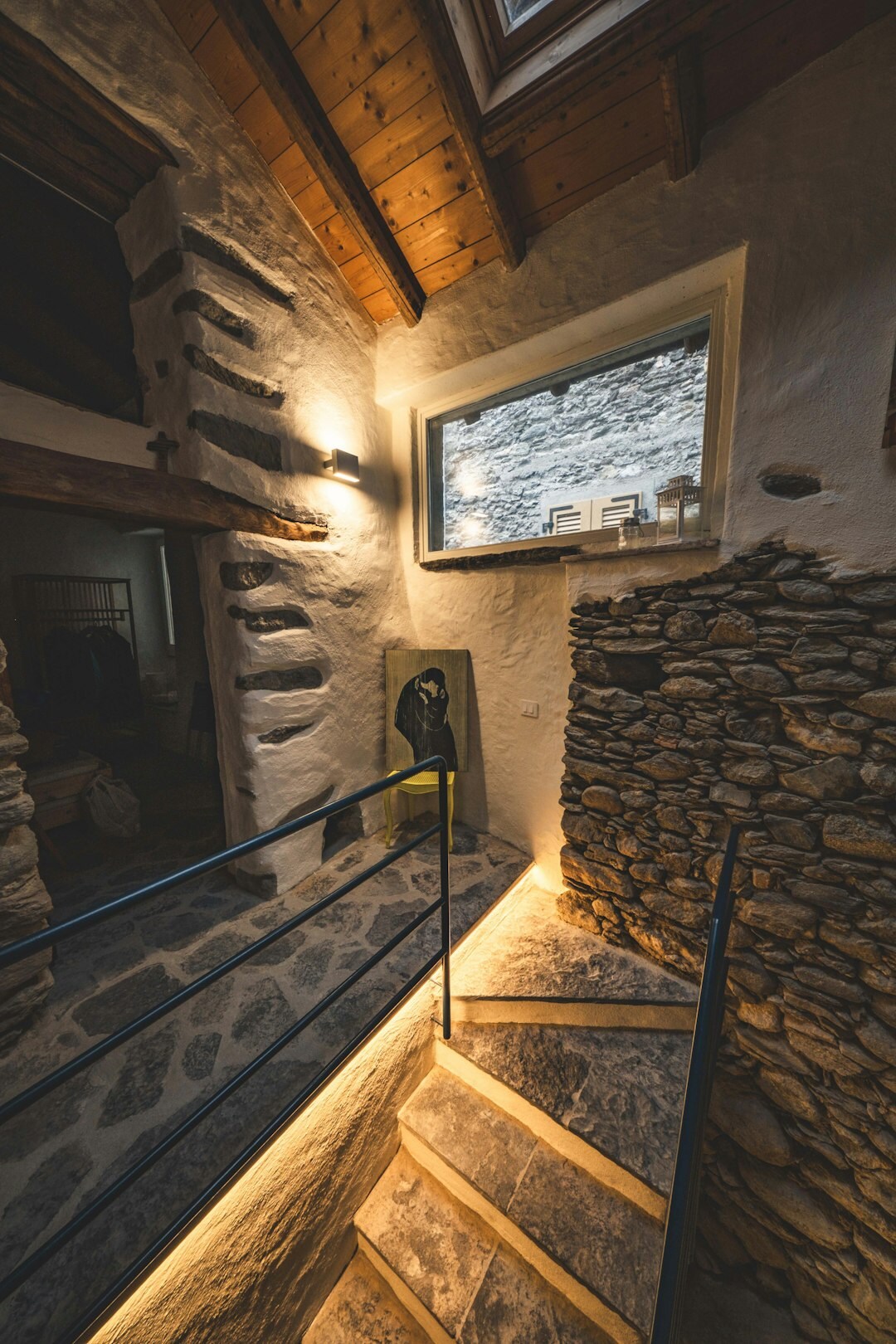 Cozy Swiss alpine chalet interior with wooden beams and stone fireplace
